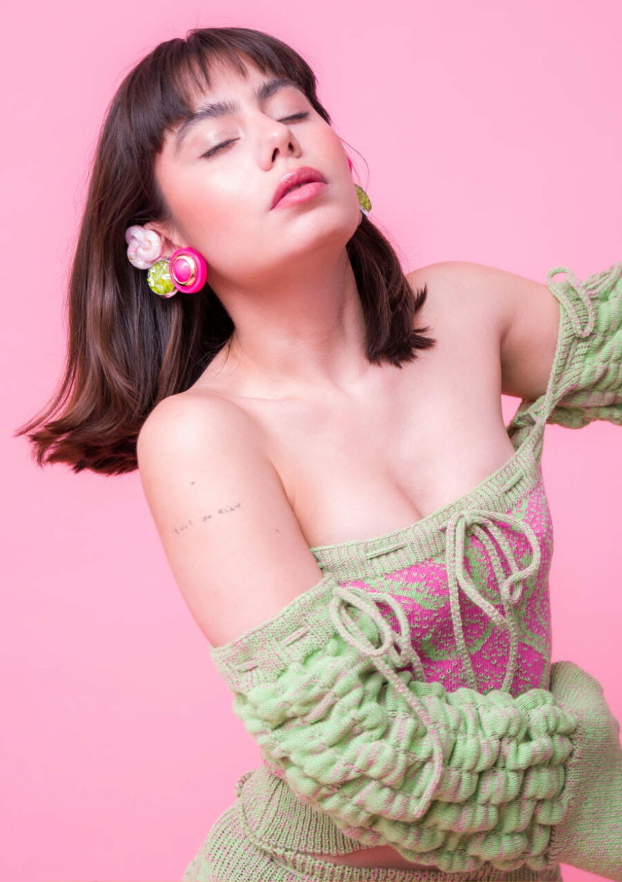 sustainable clip-on earrings on model with pink background