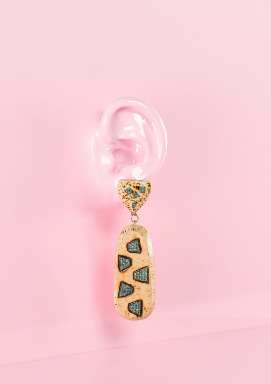 bohemian wooden drop earrings on pink background