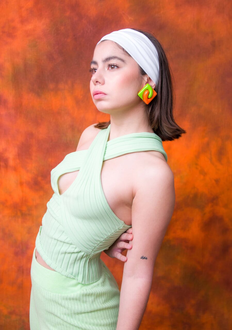 Square earrings on model with orange background