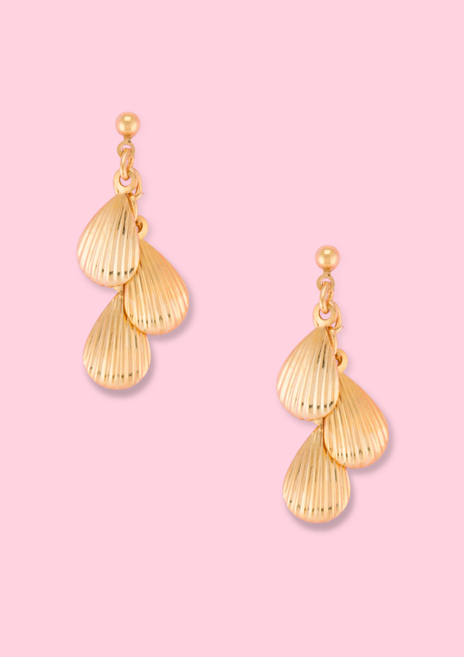 Golden shell drop earrings by live-to-express. Shop 90’s vintage ear jewellery online.